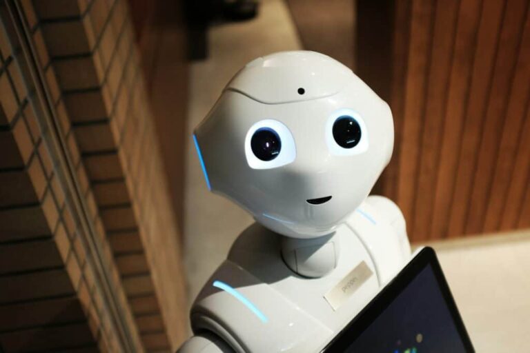 white robot holding a tablet