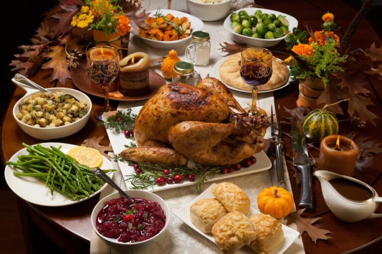 spread of thanksgiving dishes on a wooden table