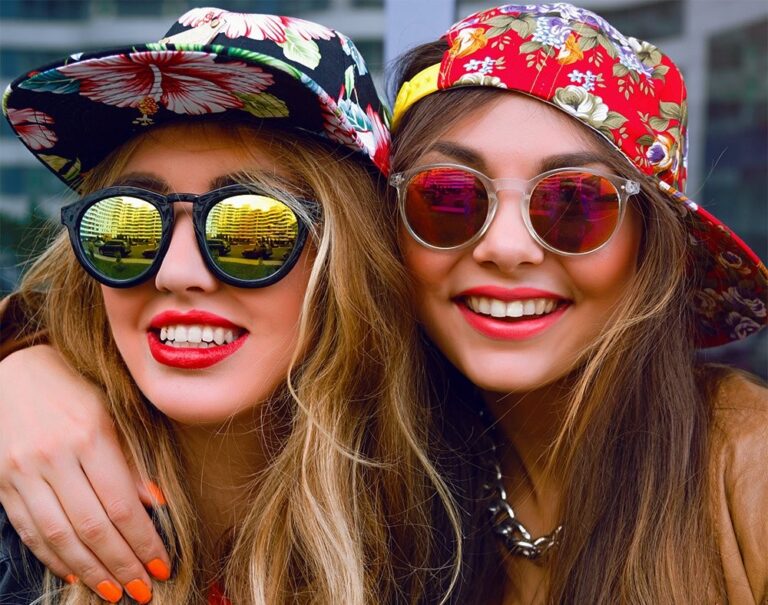 two cool girls in hats and sunglasses