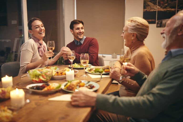 people talking to each other at the dinner table