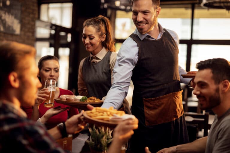 restaurant staff serving a table